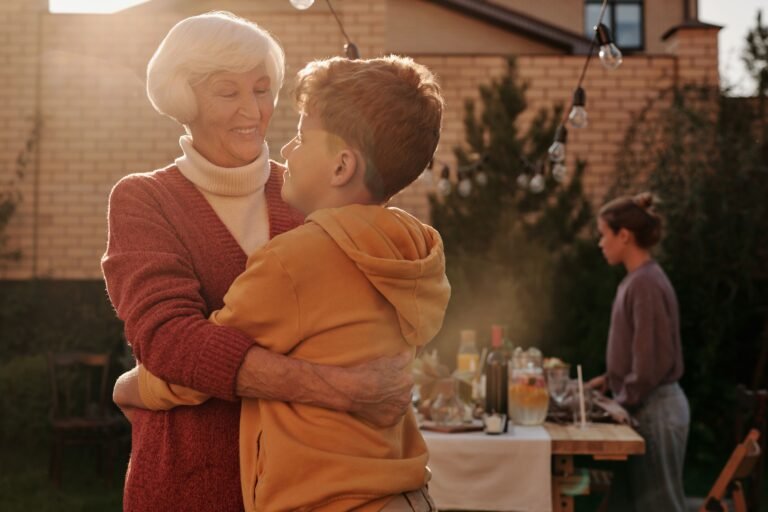 Grandparent hugging a young grandchild at home