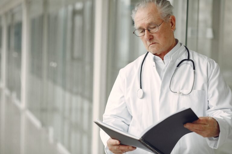 Doctor reviewing an older patient’s medical chart
