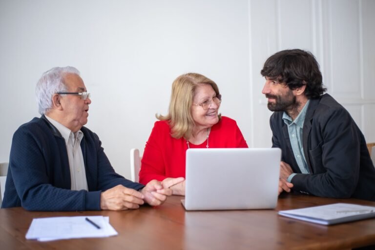 Older couple meeting with an elder law attorney at a laptop