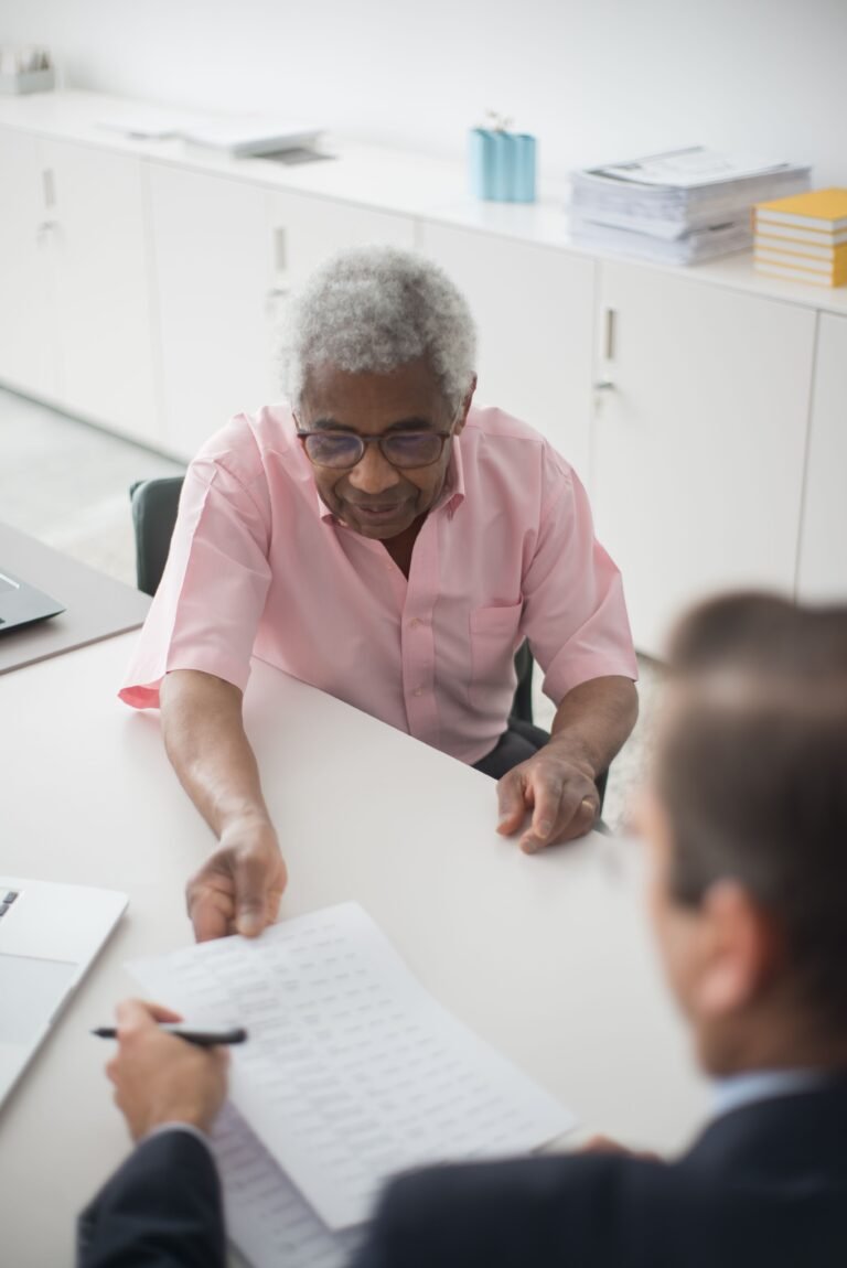Older man signing advance directive paperwork