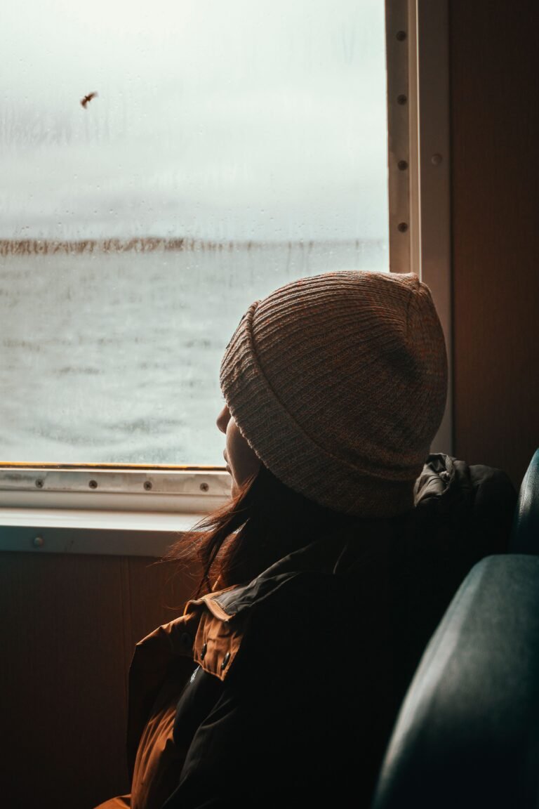 Caregiver looking out a window, lost in thought