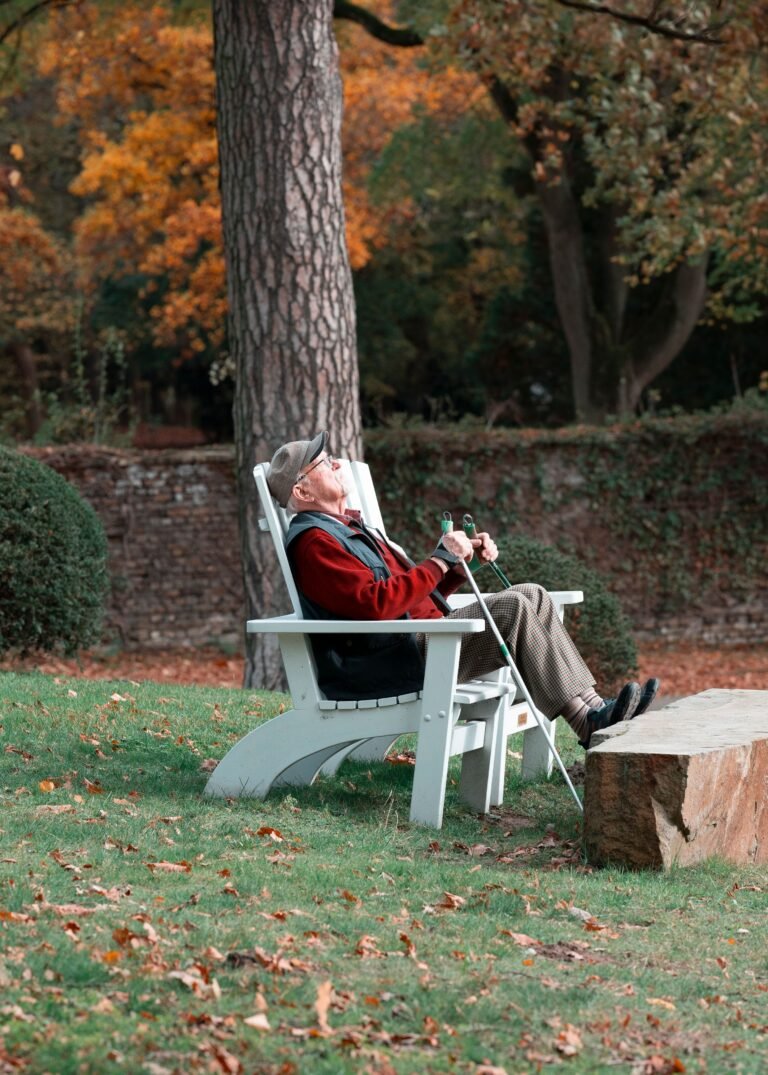 Older person resting in a garden chair outdoors