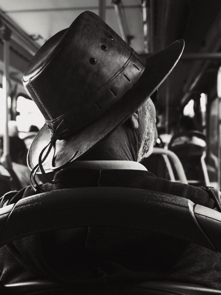 Older man riding a public bus