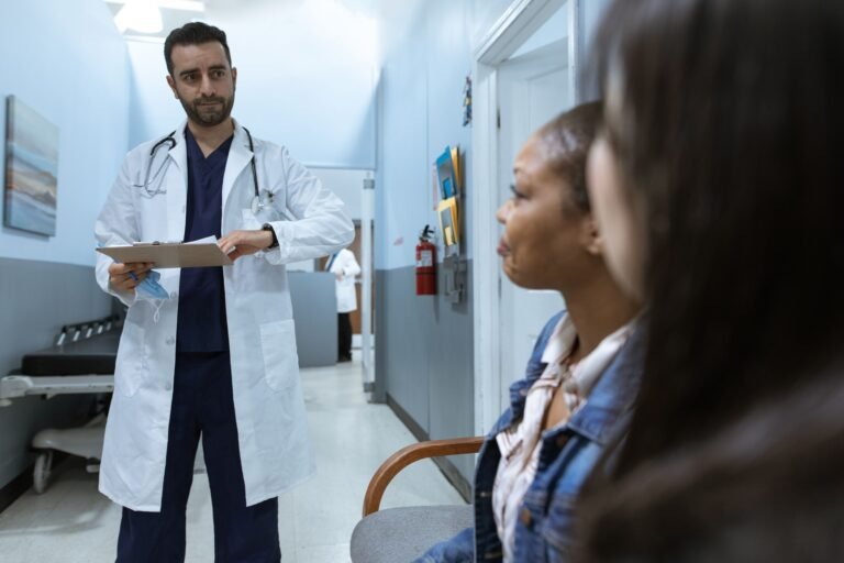 Doctor talking with a family member in a hospital corridor