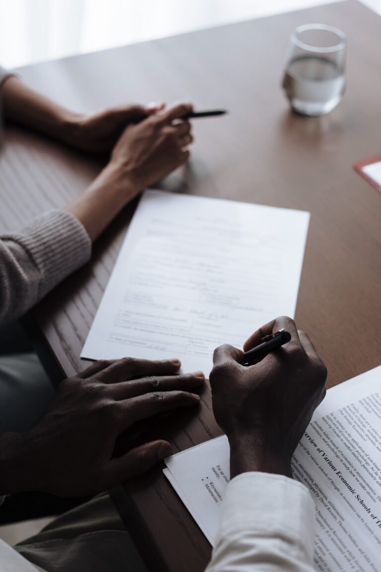 Hands signing a power of attorney document