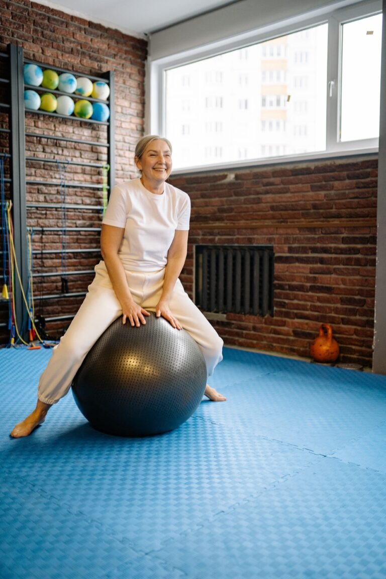 Older woman doing balance exercises on an exercise ball